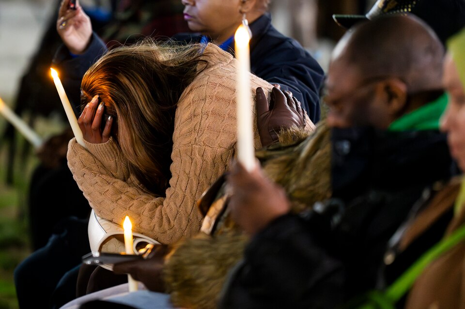 Donna Bruce holds her hand in her hands and cries during the vigil. Bruce often hosts events for bereaved mothers in Baltimore. Her son Devon died in 2021. 

Mayor Brandon Scott hosted a vigil for the homicide victims of 2023 on January 3, 2024. The names of the victims were read aloud to a crowd of people holding candles at the War Memorial Plaza in front of City Hall.