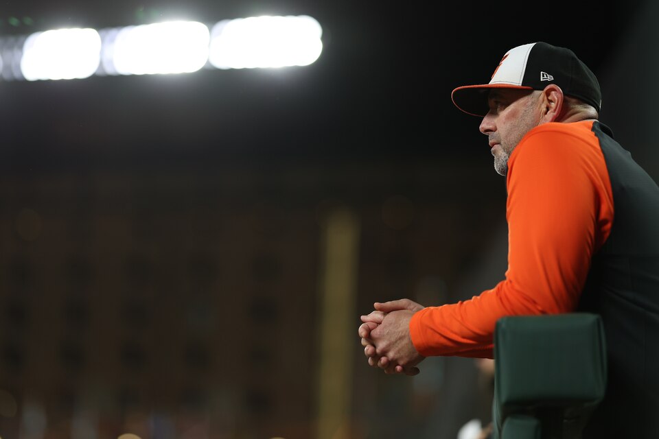Manager Brandon Hyde of the Baltimore Orioles looks on from the dugout against the Houston Astros at Oriole Park at Camden Yards on September 22, 2022 in Baltimore, Maryland.