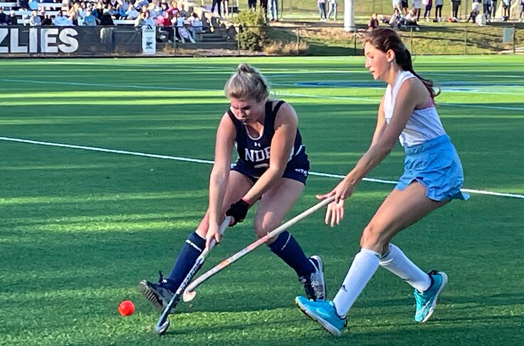 Notre Dame Prep’s Kaitlyn Cody (left) battles for the ball with Garrison Forest’s Bell Mazza in Thursday’s IAAM A Conference field hockey semifinal. With a 9-1 victory, the Grizzlies advance to Sunday’s title rematch with defending champ Archbishop Spalding. The Grizzlies are aiming for their seventh title and their first since 2019.
