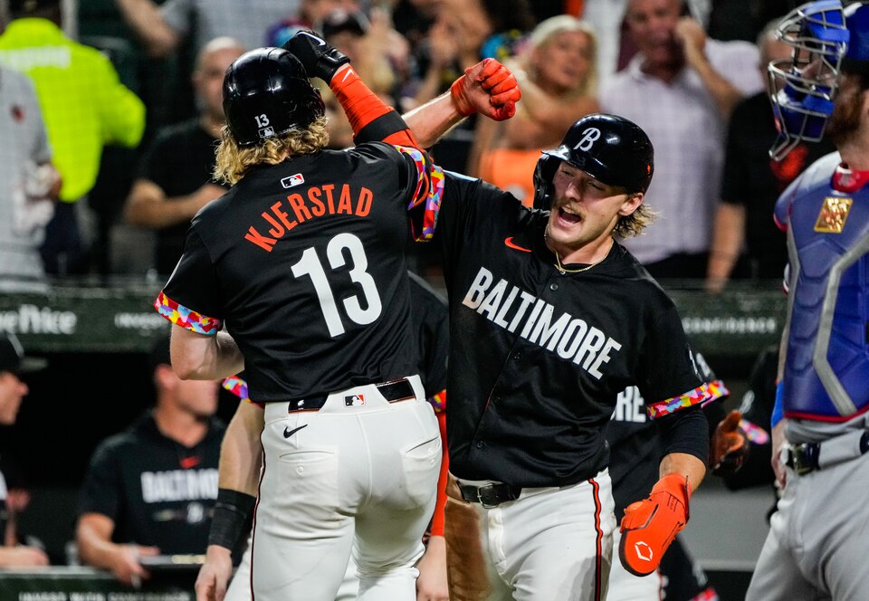 Baltimore Orioles outfielder Heston Kjerstad celebrates with Gunnar Henderson after hitting a grand slam in the third game of a series against the Texas Rangers at Camden Yards on June 29, 2024.