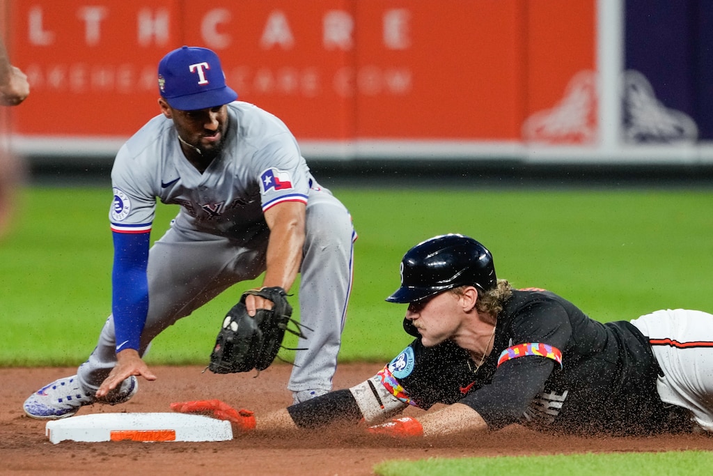 Baltimore Orioles shortstop Gunnar Henderson slides into second base in the third game of a series against the Texas Rangers at Camden Yards on June 29, 2024.