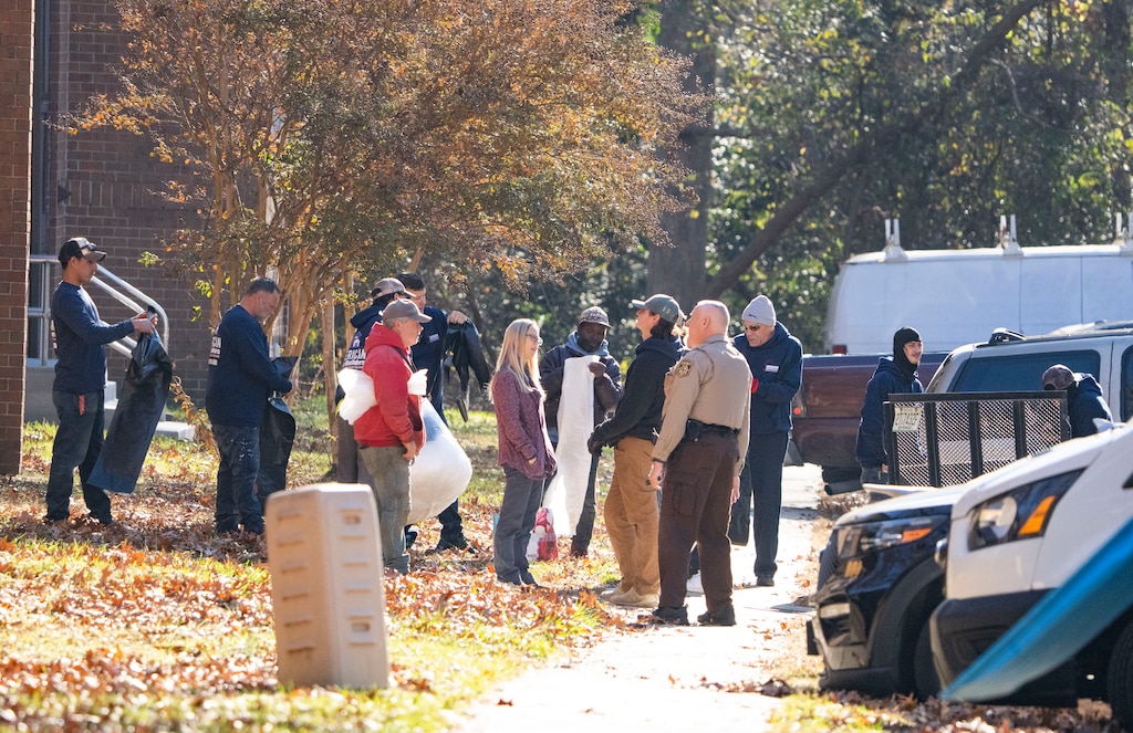 Haulers and a sheriffs deputy collect the belongings of a resident being evicted from one of the five Glen Burnie apartment communities that make up the Hendersen Webb, Inc.-owned The Forest, in Glen Burnie.
