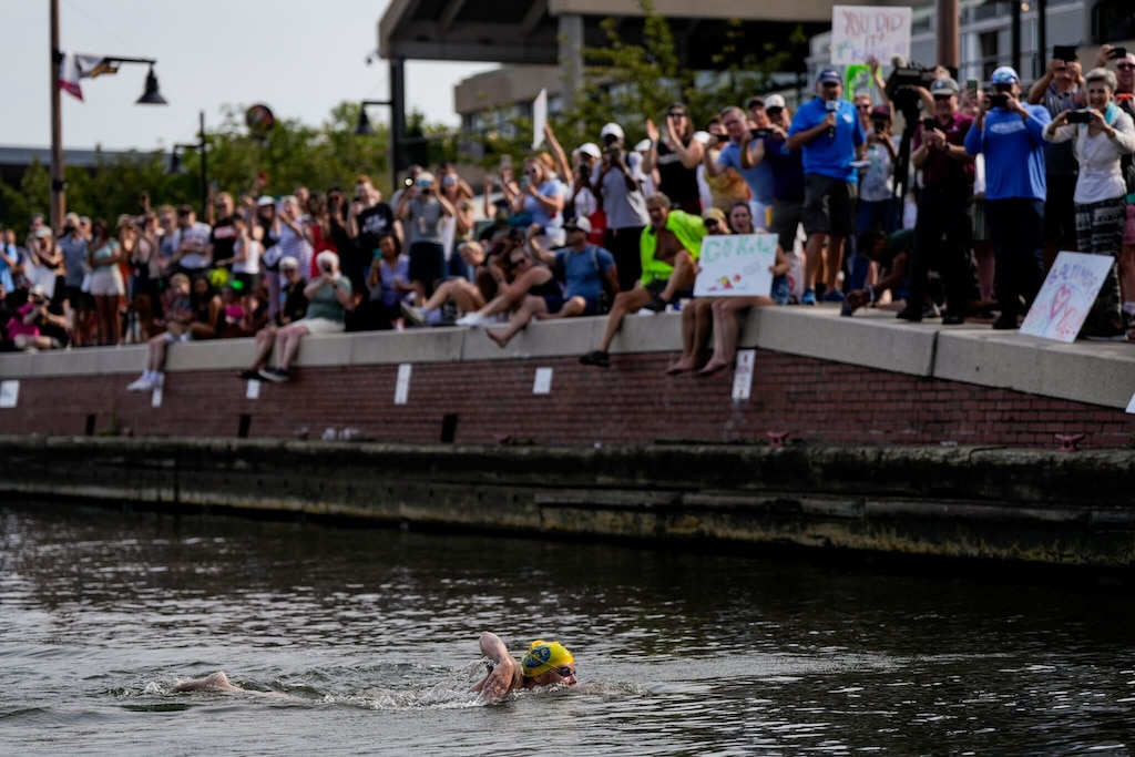 Katie Humphrey swims the final stretch of her 24-mile journey at the Inner Harbor as supporters cheer her on.
