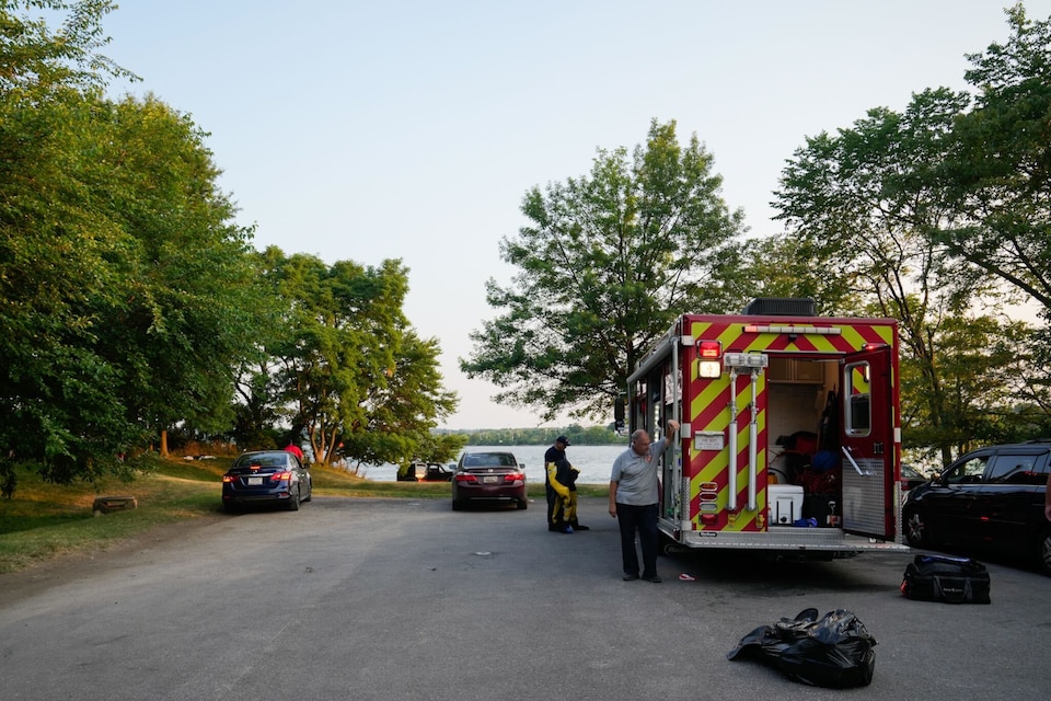 Baltimore Fire Department firefighters and dive team members pack up after rescuing three people from the water near Port Covington, June 22, 2024. A fourth person drowned.