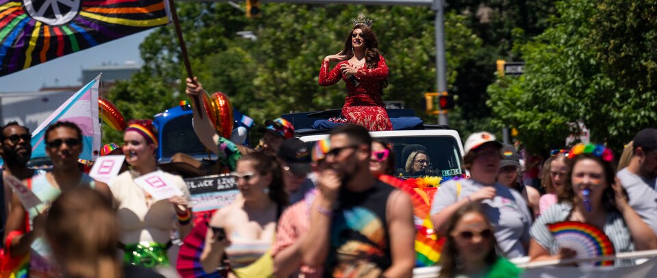 Miss Gay Maryland Stormi Skye waves as she continues down the parade route at Baltimore Pride on June 15, 2024.