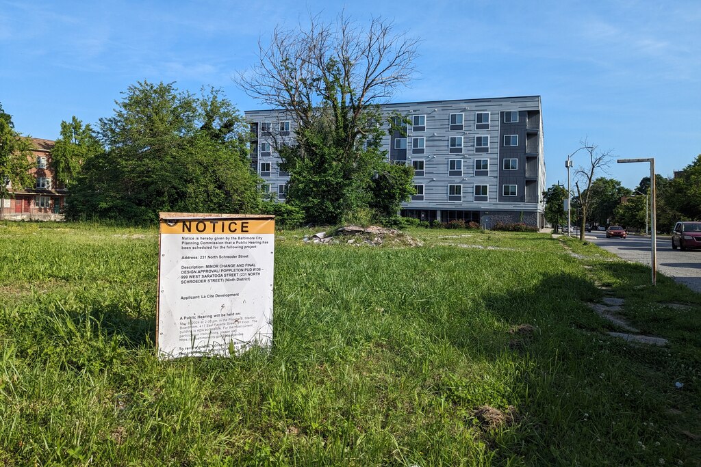 This is a photo of an empty lot where a developer wants to build an age-restricted apartment complex.