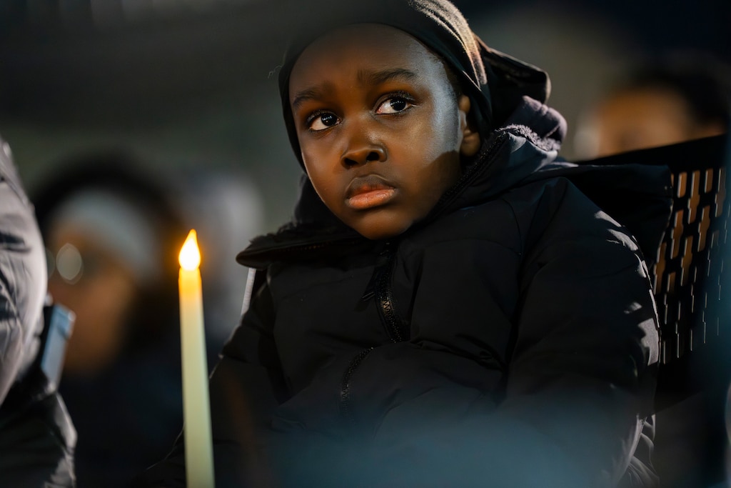 A young boy holds a candle as he listens to the names of homicide victims read aloud.

Mayor Brandon Scott hosted a vigil for the homicide victims of 2023 on January 3, 2024. The names of the victims were read aloud to a crowd of people holding candles at the War Memorial Plaza in front of City Hall.