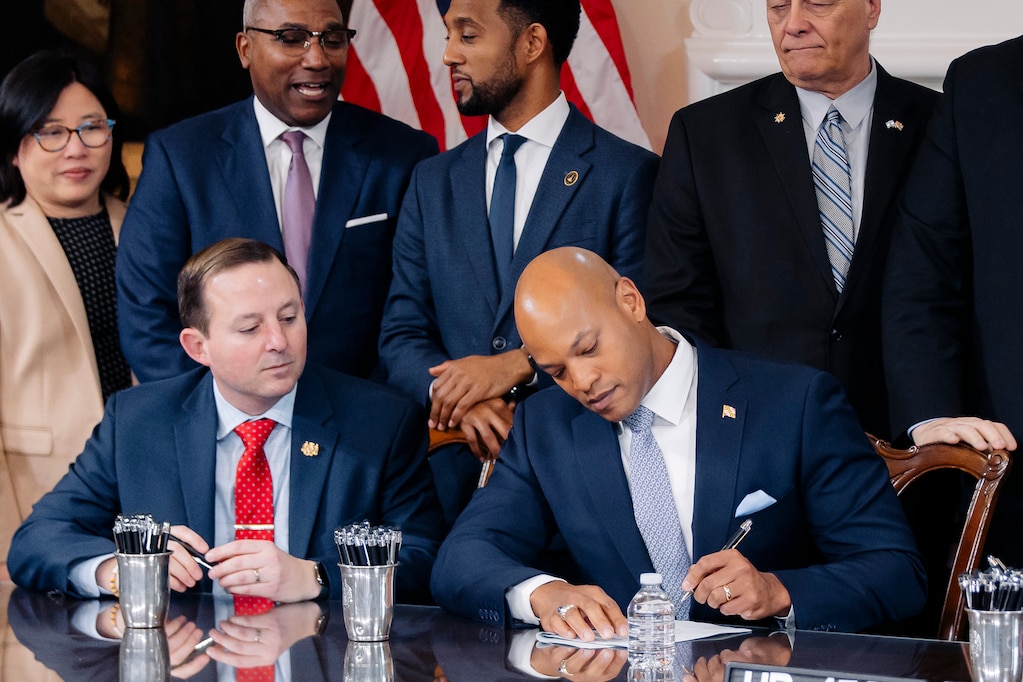Senate President Bill Ferguson and Gov. Wes Moore sign a bill into law at a bill signing ceremony following the conclusion of the 2024 Maryland General Assembly.