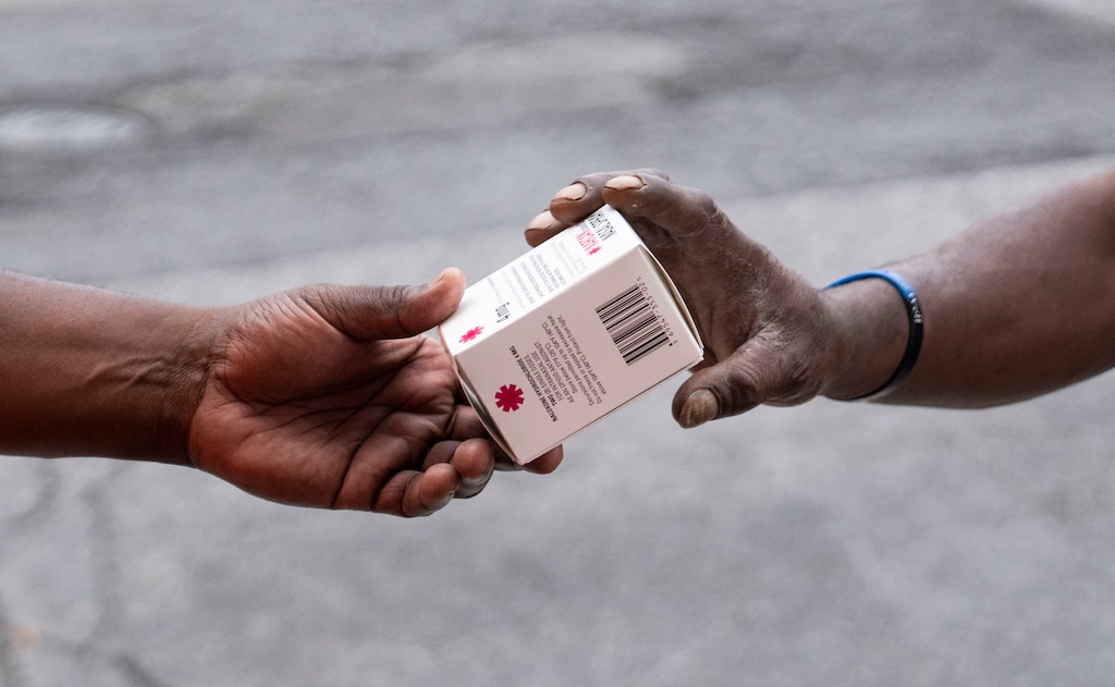 A Bmore POWER worker distributes Narcan at an intersection of Cumberland Street and Pennsylvania Avenue in Baltimore on Thursday, August 3, 2023.