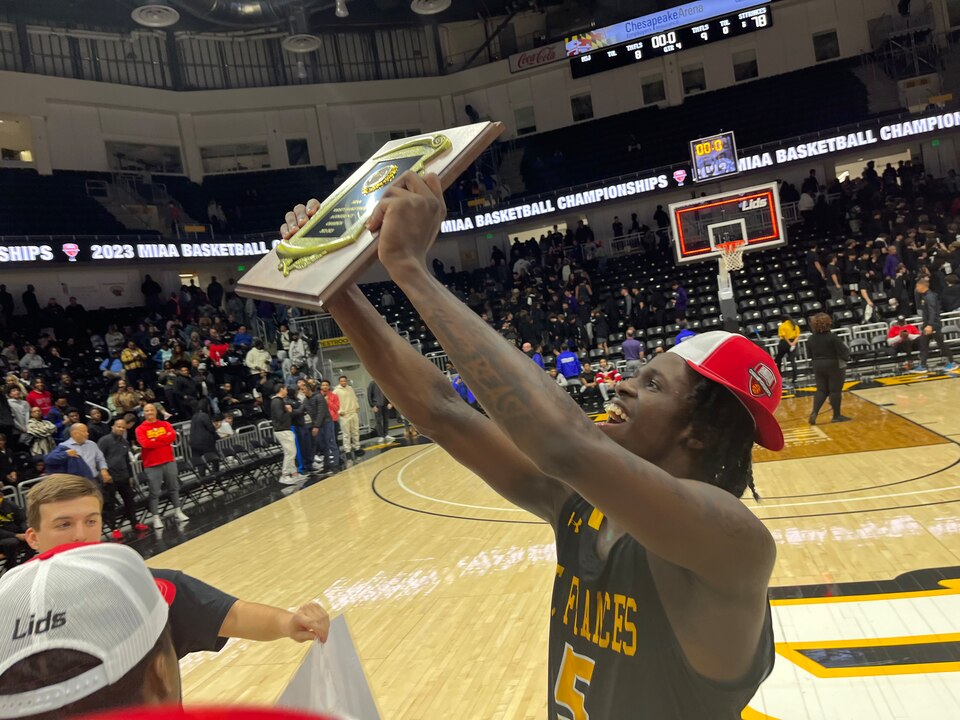 St. Frances' Jahnathan Lamothe holds up the MIAA A Conference boys basketball championship plaque Sunday evening. Lamothe finished with 30 points as the No. 2 Panthers outlasted top-ranked Mount St. Joseph, 78-75, in overtime for the title at UMBC's CEI Arena.