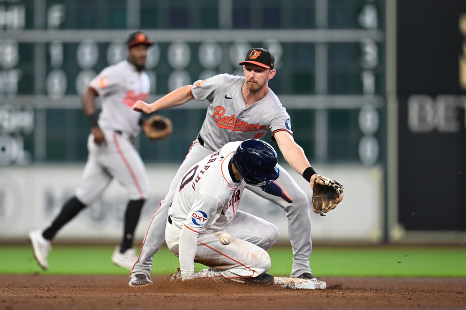 HOUSTON, TEXAS - JUNE 23: Joey Loperfido #10 of the Houston Astros steals second base while Jordan Westburg #11 of the Baltimore Orioles attempts to catch the throw during the fifth inning at Minute Maid Park on June 23, 2024 in Houston, Texas. (Photo by Jack Gorman/Getty Images)