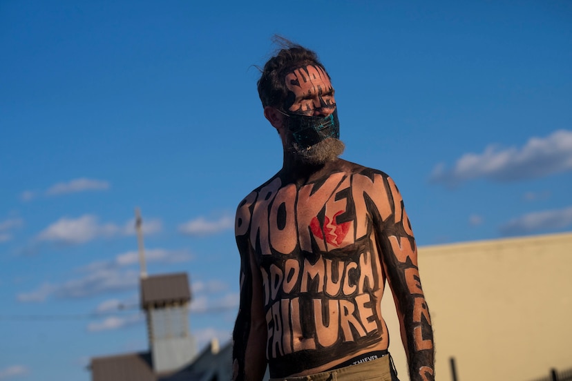 Jediah Tanguay, a survivor of Greater Grace Church, painted his body with the words "shame", "broken", and "failure", taped his mouth shut, took off his shoes and stood in front of the church on Moravia Road during their large convention on June 24, 2024 in protest.