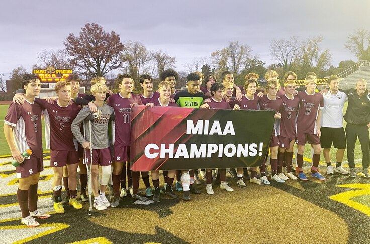 The Severn Admirals pose with a banner that proclaims their second straight MIAA B Conference soccer championship.