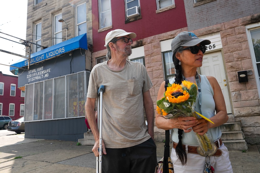 Lisa Filer and Jon Filer stand outside of Starlight Liquors in Baltimore, MD on July 20, 2023 where their son, Aidan Filer, passed away from a fentanyl overdose three years prior.