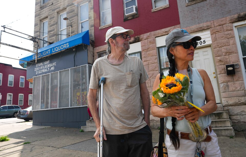 Lisa Filer and Jon Filer stand outside of Starlight Liquors in Baltimore, MD on July 20, 2023 where their son, Aidan Filer, passed away from a fentanyl overdose three years prior.