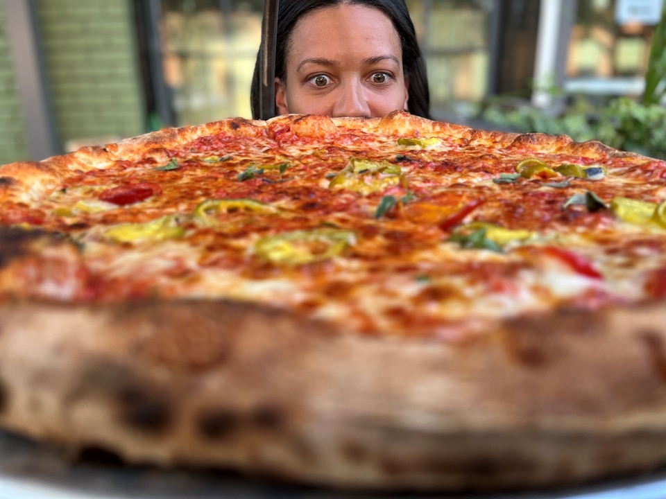 Jamyla Krempel stares down a JBGB's pizza.